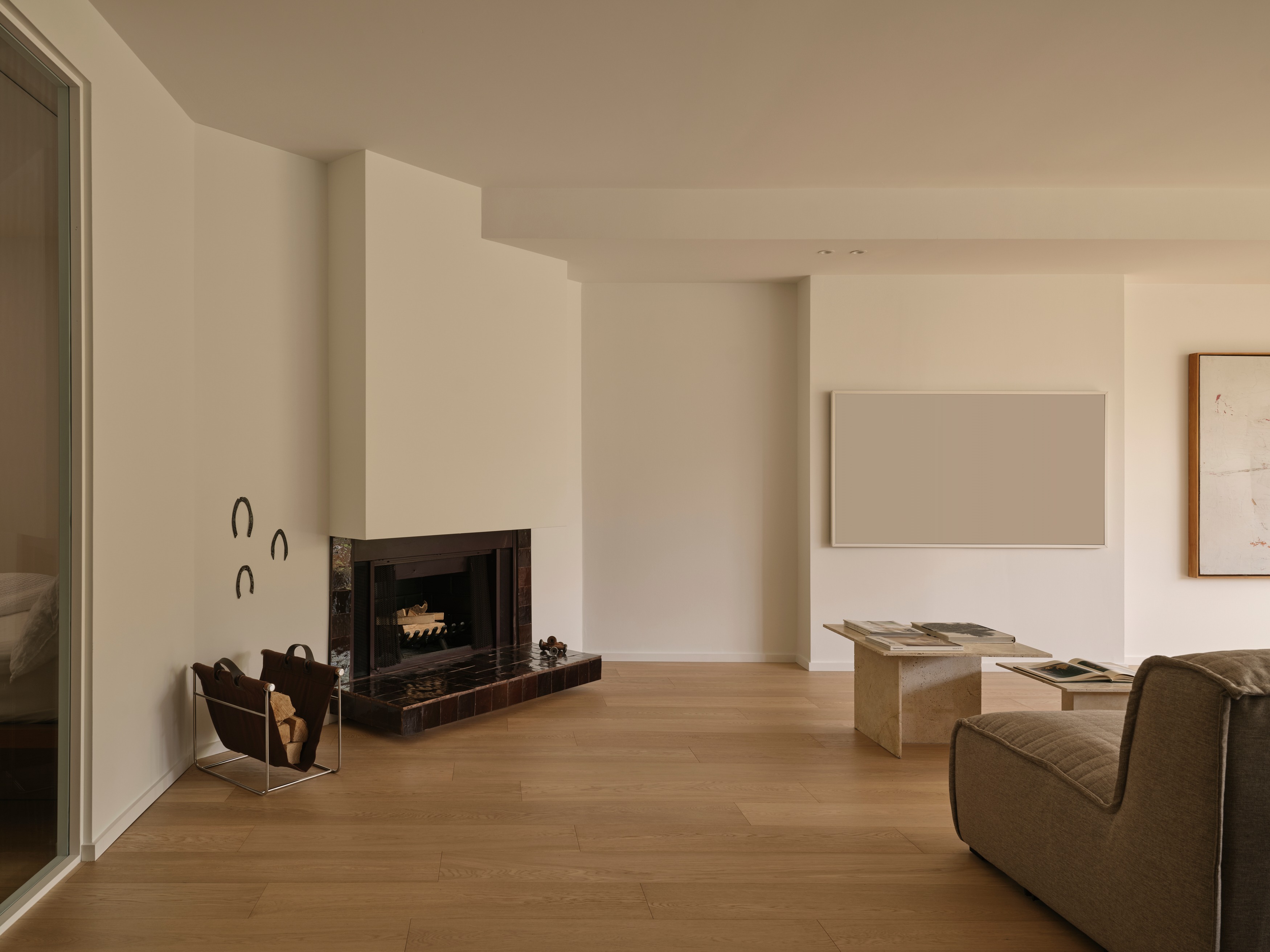 Renovated wood-burning fireplace clad in hand-made terracotta zellige tile