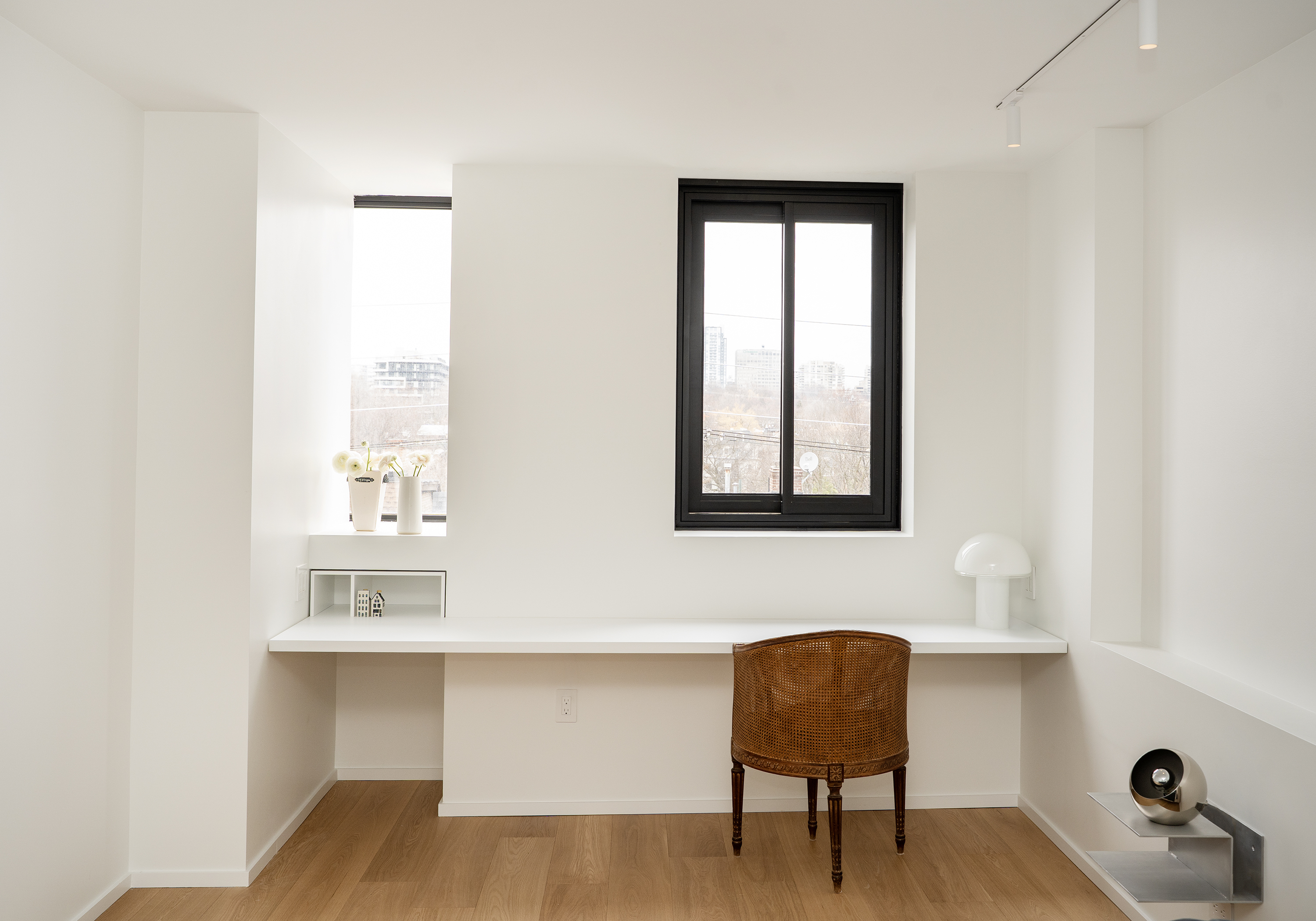 Renovated bedroom with built-in white oak desk and black-framed window